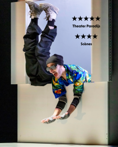 Marc is leaning through the window of the constructed White House. He has a colourful shirt on, black hat and sunglasses with a large smile on his face. Nelson's legs are sticking up from the window beside Marc.